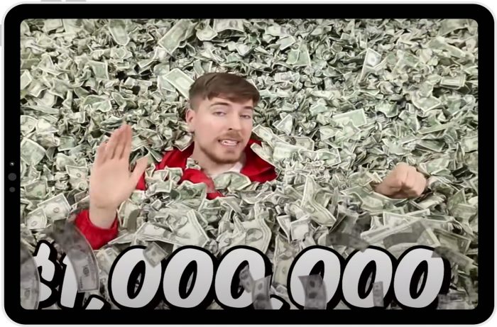 Screenshot of YouTube content creator Mr Beast showing him waving from the middle of a huge pile of dollar bills, with $1,000,000 written on the screen.